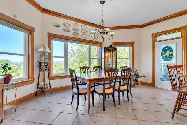 dining area featuring baseboards, ornamental molding, an inviting chandelier, and light tile patterned floors