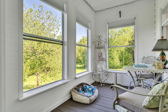 sunroom featuring a healthy amount of sunlight and hardwood / wood-style flooring
