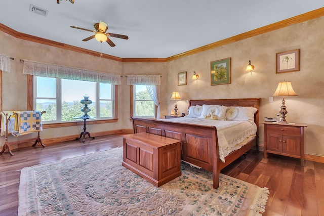 bedroom featuring baseboards, hardwood / wood-style floors, ornamental molding, and visible vents