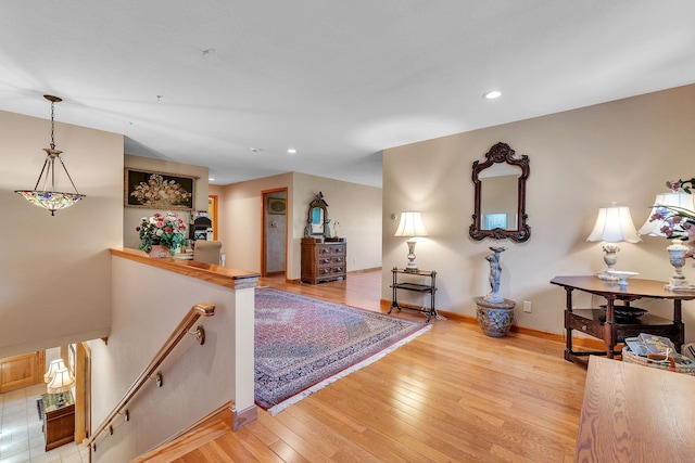 interior space featuring baseboards, light wood-style flooring, and recessed lighting