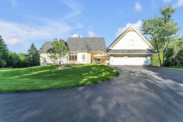 traditional home with a front lawn, driveway, and a garage