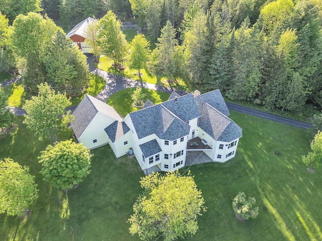 drone / aerial view featuring a wooded view