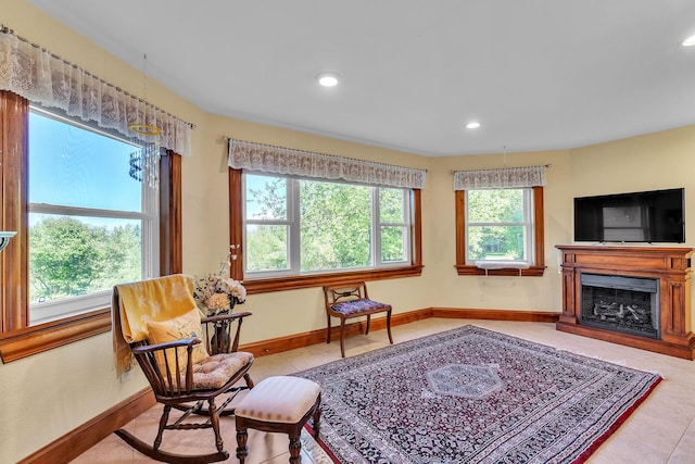 sitting room featuring light tile patterned floors, baseboards, a fireplace, and recessed lighting