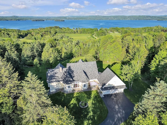 aerial view with a wooded view and a water view
