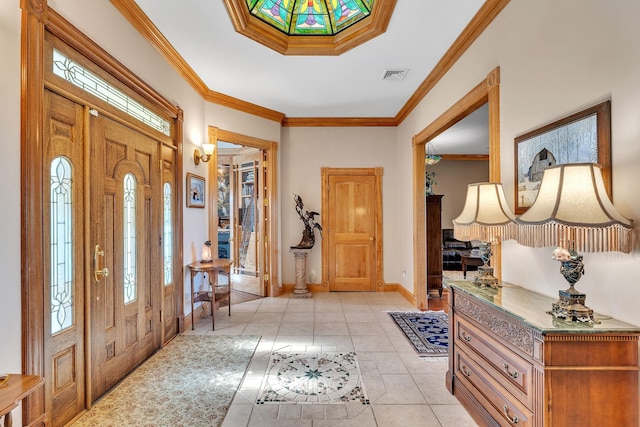 entrance foyer featuring light tile patterned floors, visible vents, baseboards, and ornamental molding