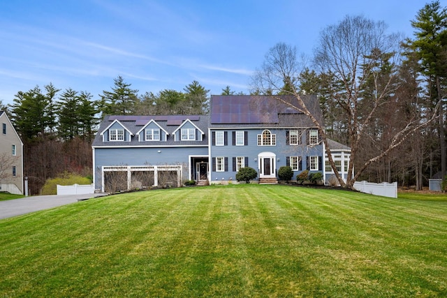 8 Palis Dr, Salisbury, MA 01952 - colonial house featuring roof mounted solar panels, fence, and a front yard