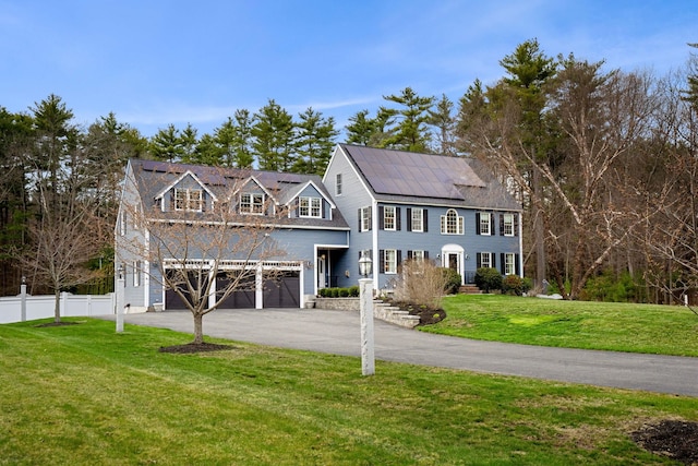 8 Palis Dr, Salisbury, MA 01952 - colonial house with fence, driveway, a garage, solar panels, and a front lawn