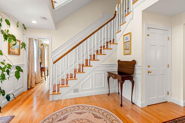 8 Palis Dr, Salisbury, MA 01952 - entrance foyer with stairs, a decorative wall, wainscoting, and wood finished floors