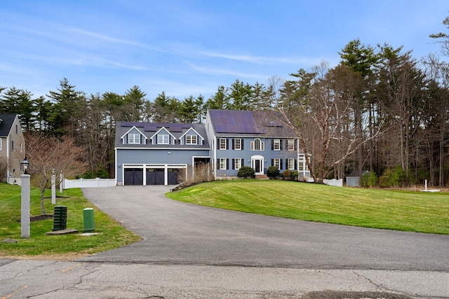 8 Palis Dr, Salisbury, MA 01952 - colonial inspired home with driveway, fence, a garage, a front lawn, and roof mounted solar panels