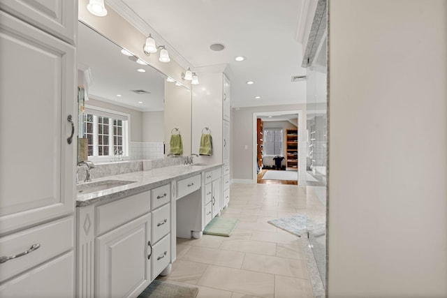 8 Palis Dr, Salisbury, MA 01952 - bathroom featuring double vanity, crown molding, recessed lighting, and a sink