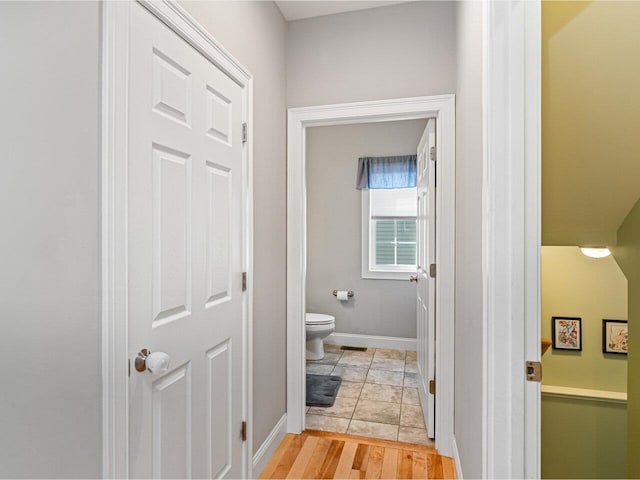 bathroom with toilet and baseboards