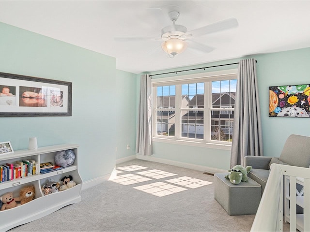 living area featuring visible vents, baseboards, ceiling fan, and carpet floors