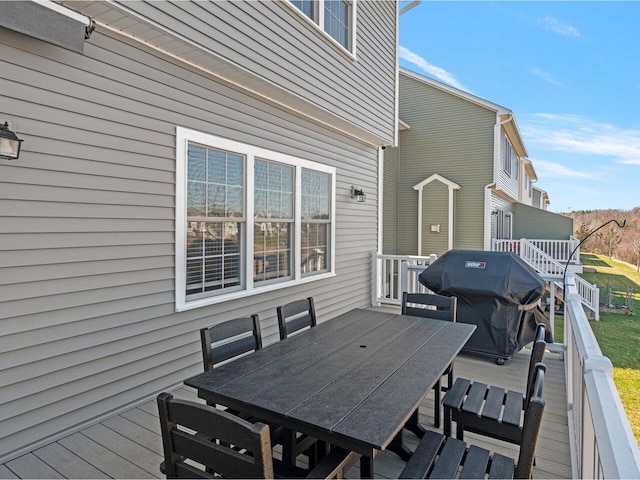 wooden deck with area for grilling and outdoor dining space