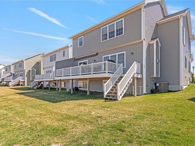 back of property with a lawn, stairs, a residential view, central AC unit, and a deck