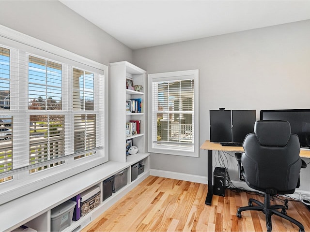 home office with baseboards and light wood finished floors