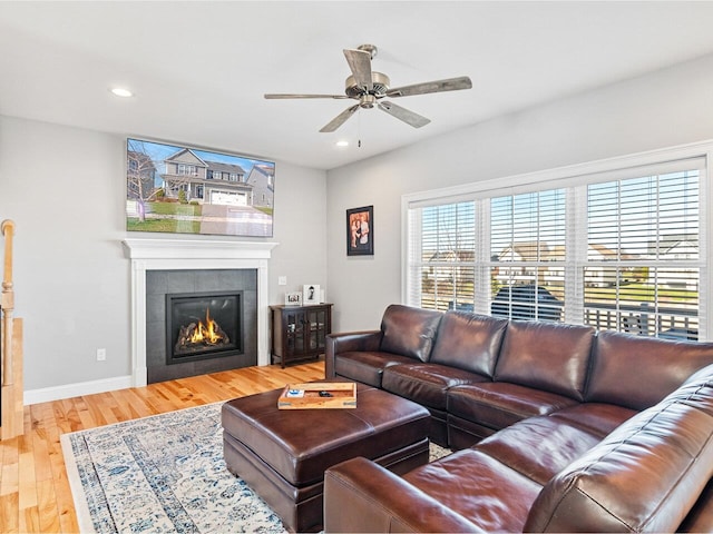 living room featuring wood finished floors, a fireplace, ceiling fan, and recessed lighting