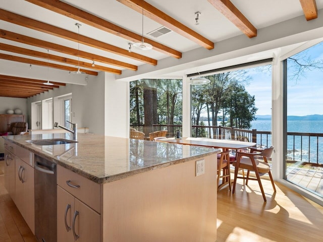 25 Oakledge Dr, Burlington, VT 05401 - kitchen featuring a water view, beamed ceiling, light wood finished floors, and a sink