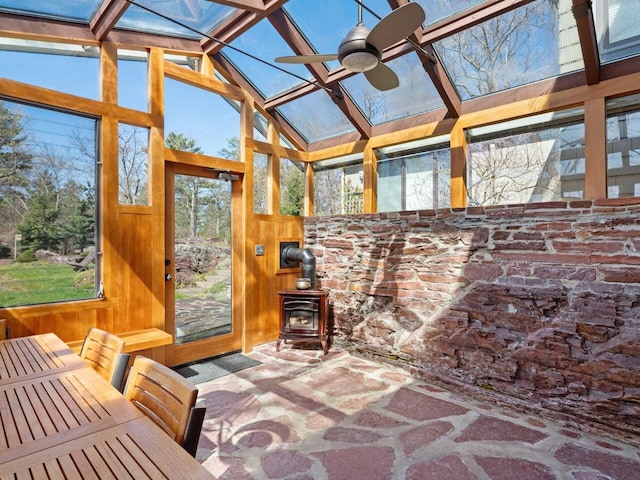 25 Oakledge Dr, Burlington, VT 05401 - sunroom with a wood stove, a skylight, wooden walls, and a healthy amount of sunlight