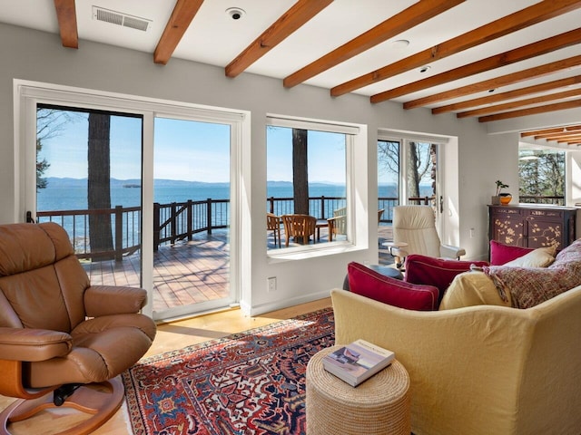 25 Oakledge Dr, Burlington, VT 05401 - living area featuring beam ceiling, a water view, baseboards, and visible vents