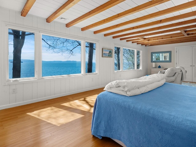 25 Oakledge Dr, Burlington, VT 05401 - bedroom with a water view, wood finished floors, visible vents, baseboards, and beamed ceiling