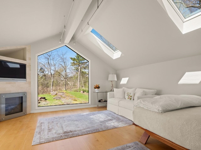 25 Oakledge Dr, Burlington, VT 05401 - living area featuring a fireplace, lofted ceiling with skylight, and wood finished floors