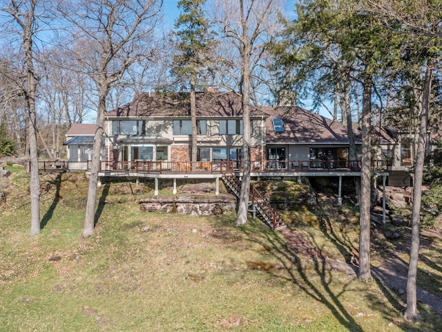 25 Oakledge Dr, Burlington, VT 05401 - back of property with a deck, stairs, a chimney, and a lawn