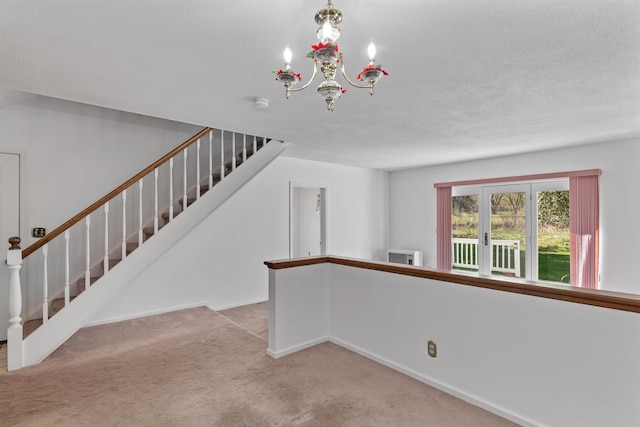stairs with baseboards, an inviting chandelier, and carpet