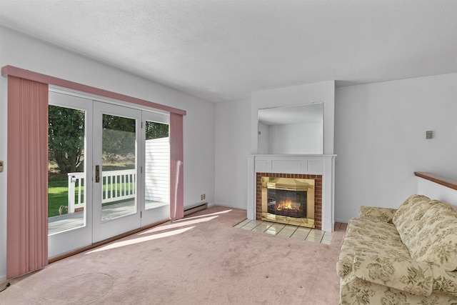 living area with french doors, a baseboard heating unit, a textured ceiling, a fireplace, and carpet flooring