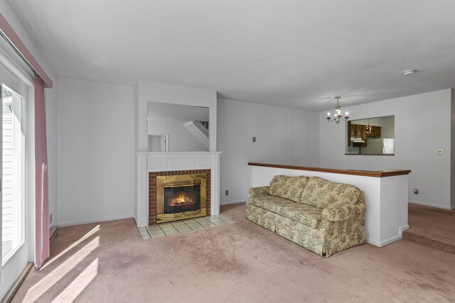 living room featuring carpet flooring, an inviting chandelier, a fireplace, and baseboards