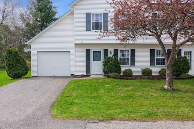 view of front of property with an attached garage, a front yard, and aphalt driveway