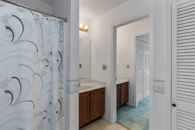 bathroom featuring a closet and vanity