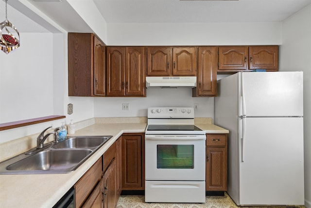 kitchen featuring under cabinet range hood, white appliances, a sink, and light countertops