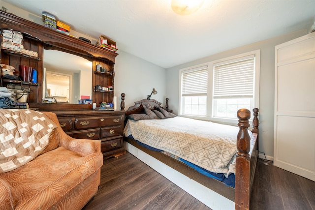 bedroom with dark wood finished floors