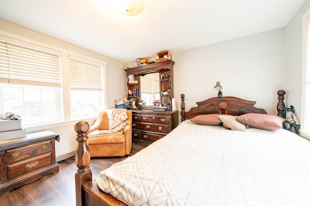 bedroom featuring wood finished floors and baseboards