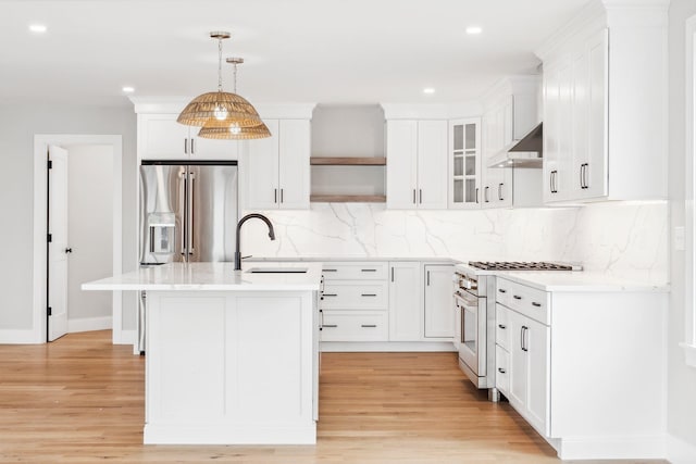 kitchen with recessed lighting, light countertops, stainless steel appliances, and a sink