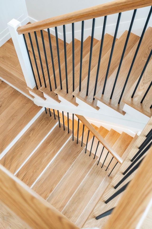 stairway featuring wood finished floors