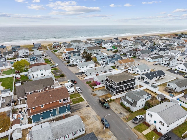 aerial view with a water view and a view of the beach