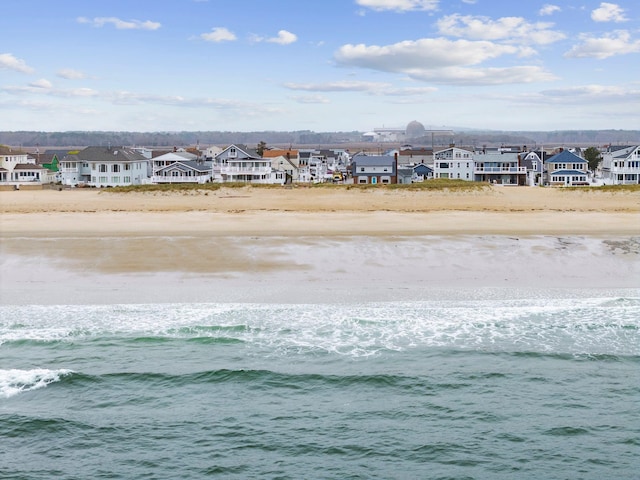 bird's eye view featuring a water view, a residential view, and a view of the beach