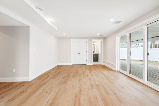 unfurnished living room featuring recessed lighting, baseboards, and light wood-style floors