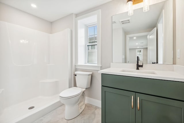 full bathroom with toilet, baseboards, a shower stall, and a healthy amount of sunlight