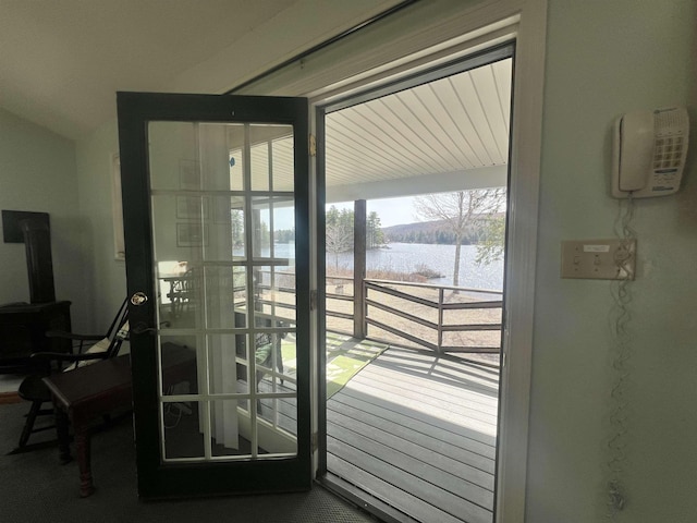 doorway with a wood stove and a water view