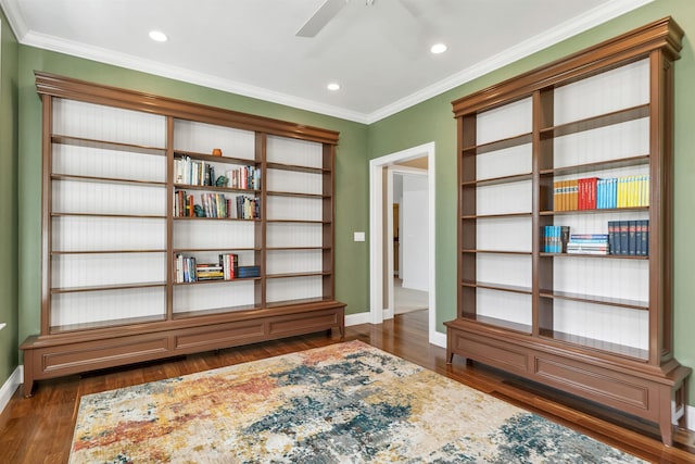 living area with dark wood-style floors, ornamental molding, baseboards, and a ceiling fan
