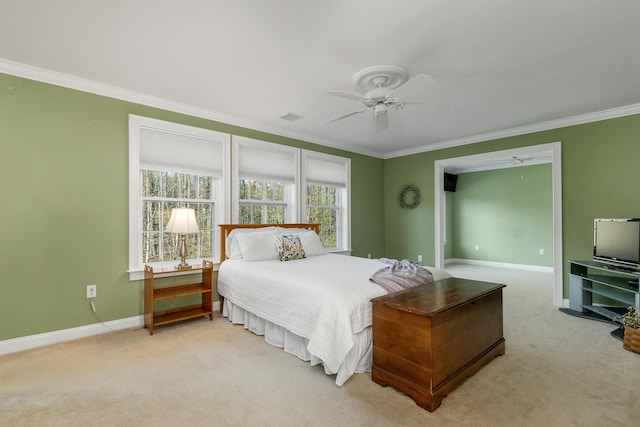 bedroom with crown molding, baseboards, and carpet