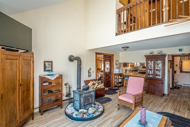 26 Private W 4, Maidstone, VT 05905 - living area featuring a wood stove, a towering ceiling, and wood tiled floor