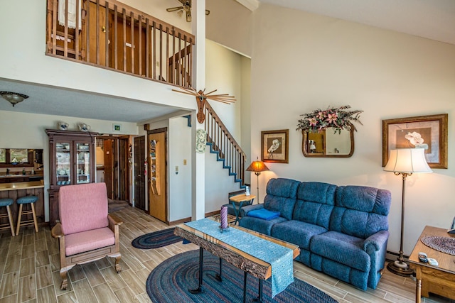 26 Private W 4, Maidstone, VT 05905 - living room featuring a high ceiling, a ceiling fan, wood finish floors, and stairs