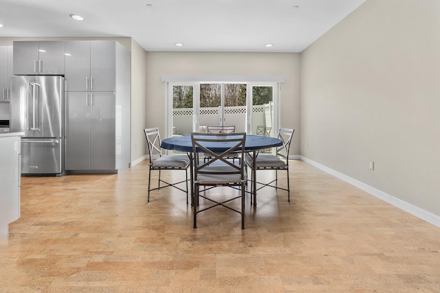 dining room with baseboards and recessed lighting