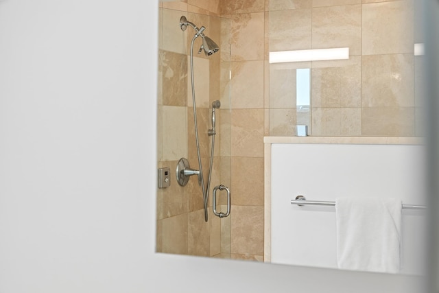 full bath with a tile shower