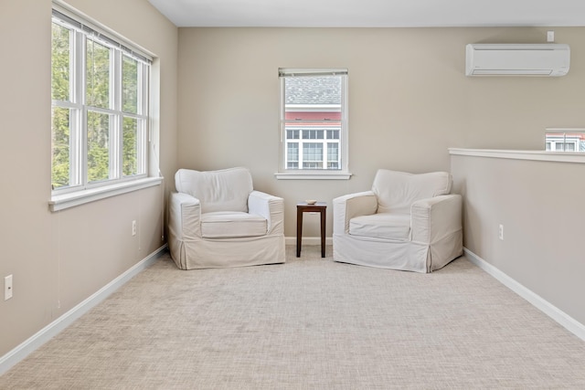sitting room with baseboards, a wealth of natural light, a wall mounted air conditioner, and carpet