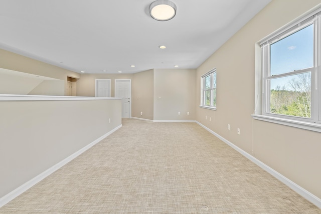 empty room with light colored carpet, baseboards, and recessed lighting