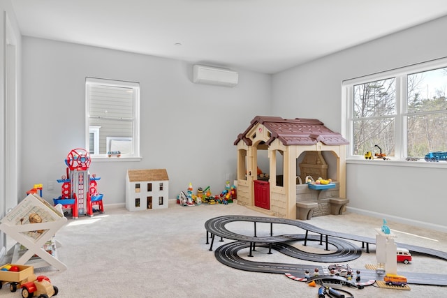 recreation room featuring carpet, baseboards, and a wall unit AC
